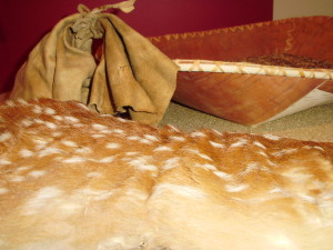 Rice storage containers on display at North West Company Fur Post, Pine City. The spotted container is literally a fawn-skin taken off nearly whole for use as rice sack. Sometimes written in fur trade records as a “fan” (“faon” is the French word for “fawn”), these versatile containers had an average capacity of two bushels. English speakers like Sayer refer to it as a “bag of oats,” but fans were first mentioned by Jonathan Carver in his Travels published in London in 1781. Similarly, grease was often traded in bladders; the grease from processing a slaughtered animal was packed and stored in the animal’s own seamless bladder.